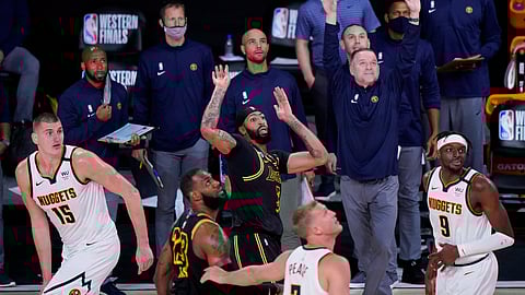 Los Angeles Lakers' Anthony Davis (3) watches his last second 3-point basket between Denver Nuggets' Nikola Jokic (15) and Jerami Grant (9) in an NBA conference final playoff basketball game Sunday, Sept. 20, 2020, in Lake Buena Vista, Fla. The Lakers won 105-103.