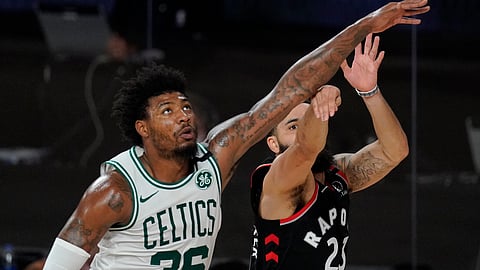 Toronto Raptors' Fred VanVleet (23) makes a 3-point basket in front of Boston Celtics' Marcus Smart (36) at the end of the first half of an NBA conference semifinal playoff basketball game Saturday, Sept. 5, 2020, in Lake Buena Vista, Fla.