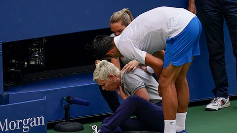Novak Djokovic, of Serbia, checks a lineswoman after hitting her with a ball in reaction to losing a point to Pablo Carreno Busta, of Spain, during the fourth round of the US Open tennis championships, Sunday, Sept. 6, 2020, in New York. Djokovic defaulted the match.