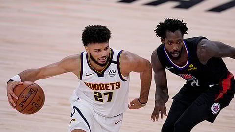 Denver Nuggets guard Jamal Murray (27) drives around LA Clippers guard Patrick Beverley (21) during the first half of an NBA conference semifinal playoff basketball game Tuesday, Sept. 15, 2020, in Lake Buena Vista, Fla.