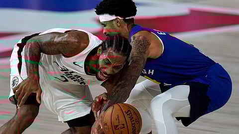 Los Angeles Clippers' Kawhi Leonard, left, is fouled by Denver Nuggets' Gary Harris during the second half of an NBA conference semifinal playoff basketball game, Friday, Sept. 11, 2020, in Lake Buena Vista, Fla.