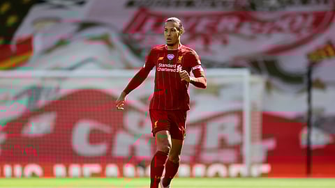 FILE - In this Sunday, July 5, 2020 file photo, Liverpool's Virgil van Dijk runs with the ball during theie English Premier League soccer match against Aston Villa at Anfield Stadium in Liverpool, England.