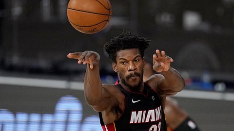 Miami Heat's Jimmy Butler (22) passes in the first half of an NBA conference semifinal playoff basketball game against the Milwaukee Bucks Tuesday, Sept. 8, 2020 in Lake Buena Vista, Fla.