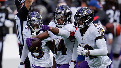 Baltimore Ravens cornerback Marlon Humphrey (44) celebrates after intercepting a pass, during an NFL football game against the Cleveland Browns, Sunday, Sept. 13, 2020, in Baltimore. To the right Baltimore Ravens safety DeShon Elliott (32) and cornerback Tavon Young (25), left.