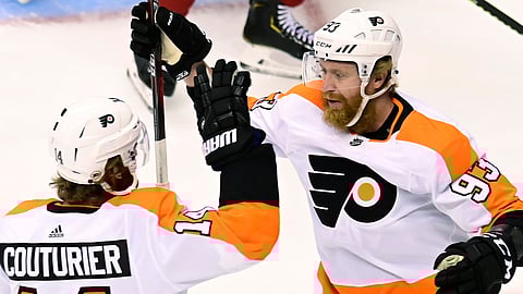 Philadelphia Flyers right wing Jakub Voracek (93) celebrates his goal against the Montreal Canadiens with Sean Couturier (14) during the first period of Game 3 of an NHL hockey playoff first-round series Sunday, Aug. 16, 2020, in Toronto.