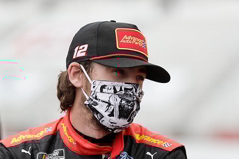 FILE - This June 7, 2020, file photo shows Ryan Blaney waiting in pit row before a NASCAR Cup Series auto race at Atlanta Motor Speedway in Hampton, Ga. With a bit of disbelief over his fast fall in NASCAR's standings, Ryan Blaney is determined to avoid elimination from the playoffs.