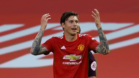 Manchester United's Victor Lindelof reacts after a penalty is awarded to Crystal Palace upon VAR review during the English Premier League soccer match between Manchester United and Crystal Palace at the Old Trafford stadium in Manchester, England, Saturday, Sept. 19, 2020.