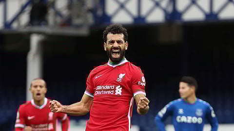 Liverpool's Mohamed Salah, 11, celebrates scoring his side's second goal during the English Premier League soccer match between Everton and Liverpool at Goodison Park stadium, in Liverpool, England, Saturday, Oct. 17, 2020.