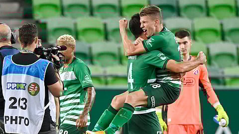 In this Wednesday, Sept. 16, 2020 photo, David Siger, right, and Ihor Kharatin of Ferencvaros celebrate their win against Dinamo Zagreb after their Champions' League qualifying third round soccer match in Groupama Arena in Budapest, Hungary.