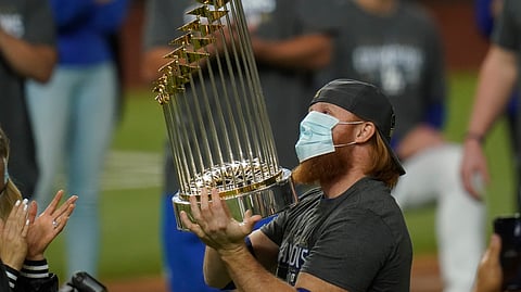 Los Angeles Dodgers third baseman Justin Turner celebrates with the trophy after defeating the Tampa Bay Rays 3-1 to win the baseball World Series in Game 6 Tuesday, Oct. 27, 2020, in Arlington, Texas.