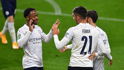 Manchester City's Ferran Torres, right, celebrates with Manchester City's Raheem Sterling after scoring his side's third goal during the EFL Cup 4th round soccer match between Burnley and Manchester City at Turf Moor in Burnley, England, Wednesday, Sept. 30, 2020.