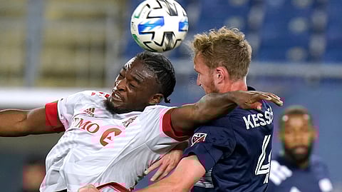Toronto FC's Ayo Akinola, left, vies for control of the ball with New England Revolution's Henry Kessler during the second half of an MLS soccer match, Wednesday, Oct. 7, 2020, in Foxborough, Mass. Akinola scored in the first half to help Toronto FC win 1-0.