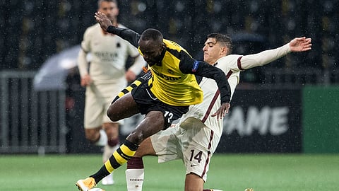 Young Boys' Nicolas Moumi Ngamaleu, left, in action against Roma's Gonzalo Villar during the Europa League group stage Group A soccer match between Switzerland's BSC Young Boys Bern and Italy's AS Roma, at the Wankdorf stadium in Berne, Switzerland, Thursday, Oct. 22, 2020.
