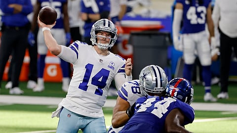 Dallas Cowboys quarterback Andy Dalton (14) throws a pass as New York Giants linebacker Markus Golden (44) pressures in the second half of an NFL football game in Arlington, Texas, Sunday, Oct. 11, 2020.