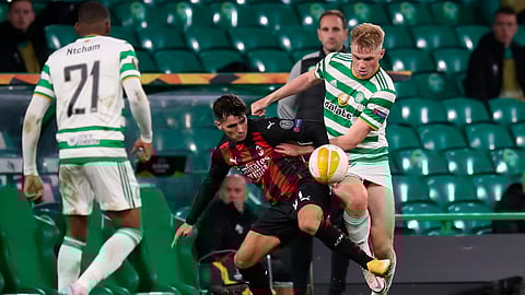 Celtic's Stephen Welsh, right, and AC Milan's Brahim Diaz, center, fight for the ball during the Europa League Group H first leg soccer match between Celtic and AC Milan at the Celtic Park stadium in Glasgow, Scotland, Thursday, Oct. 22, 2020.