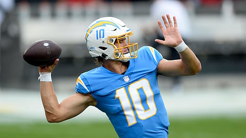 Los Angeles Chargers quarterback Justin Herbert (10) throws a pass before an NFL football game against the Tampa Bay Buccaneers Sunday, Oct. 4, 2020, in Tampa, Fla.