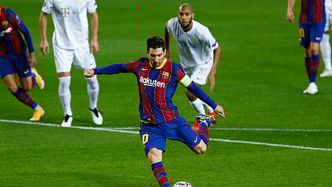 Barcelona's Lionel Messi scores a penalty during the Champions League group G soccer match between FC Barcelona and Ferencvaros at the Camp Nou stadium in Barcelona, Spain, Tuesday, Oct. 20, 2020.