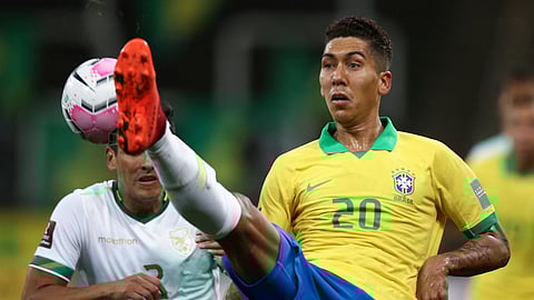 Brazil's Roberto Firmino, right, fights for the ball with Bolivia's Gabriel Valverde during a qualifying soccer match for the FIFA World Cup Qatar 2022 at the Neo Quimica arena in Sao Paulo, Brazil, Friday, Oct. 9, 2020.