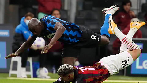 AC Milan's Theo Hernandez, bottom, and Inter Milan's Romelu Lukaku vie for the ball during the Serie A soccer match between Inter Milan and AC Milan at the San Siro Stadium, in Milan, Italy, Saturday, Oct. 17, 2020. (AP Photo/Antonio Calanni)