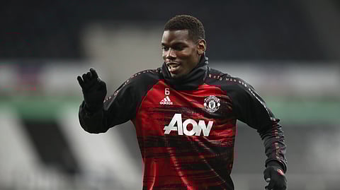 Manchester United's Paul Pogba warms up prior to the English Premier League soccer match between Newcastle United and Manchester United at St. James' Park in Newcastle, England, Saturday, Oct. 17, 2020.