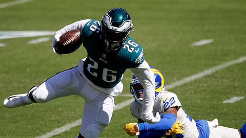 Eagles running back Miles Sanders runs past the Rams' Troy Hill earlier this season