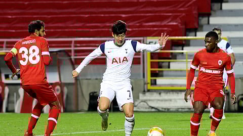 Tottenham's Son Heung-min, center, vies for the ball against Royal Antwerp's Faris Haroun, left, during the Europa League Group J soccer match between Antwerp and Tottenham at the Bosuil stadium in Antwerp, Belgium, Thursday, Oct. 29, 2020.