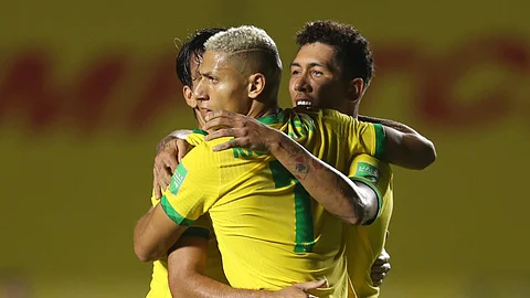 Brazil's Roberto Firmino, right, celebrates with teammates after scoring his side's opening goal against Venezuela during a qualifying soccer match for the FIFA World Cup Qatar 2022 in Sao Paulo, Brazil, Friday, Nov.13, 2020.