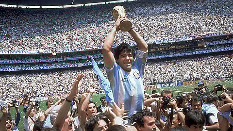 In this June 29, 1986 file photo, Diego Maradona holds up his team's trophy after Argentina's 3-2 victory over West Germany at the World Cup final soccer match at Azteca Stadium in Mexico City. The Argentine soccer great was among the best players ever and led his country to the 1986 World Cup title.