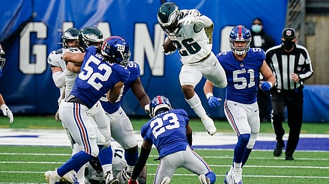 Eagles running back Miles Sanders (26) leaps over New York Giants' Logan Ryan (23) in East Rutherford, N.J., on Nov. 15
