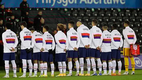 US team stand for their national anthem before the international friendly soccer match between Wales and USA at Liberty stadium in Swansea, Wales, Thursday, Nov. 12, 2020.