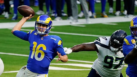 Los Angeles Rams quarterback Jared Goff (16) throws under pressure from Seattle Seahawks defensive tackle Poona Ford (97) during the first half of an NFL football game Sunday, Nov. 15, 2020, in Inglewood, Calif.