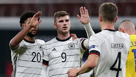 Germany's Timo Werner, centre, celebrates with teammates Serge Gnabry, left, and Matthias Ginter, right, after scoring his team's third goal during the UEFA Nations League soccer match between Germany and the Ukraine at the Red Bull Arena in Leipzig, Germany, Saturday, Nov. 14, 2020. (AP Photo/Michael Sohn)