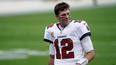 Tampa Bay Buccaneers quarterback Tom Brady (12) walks the turf before the first half of an NFL football game between the Carolina Panthers and the Tampa Bay Buccaneers, Sunday, Nov. 15, 2020, in Charlotte , N.C.