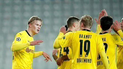 Dortmund's Erling Haaland, left, celebrates after scoring his sides third goal of the match during the Champions League Group F soccer match between Brugge and Borussia Dortmund at the Jan Breydel stadium in Bruges, Belgium, Wednesday, Nov. 4, 2020.