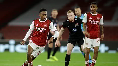 Arsenal's Joe Willock looks to pass the ball during the Europa League Group B soccer match between Arsenal and Dundalk at the Emirates Stadium in London, Thursday, Oct. 29. 2020.