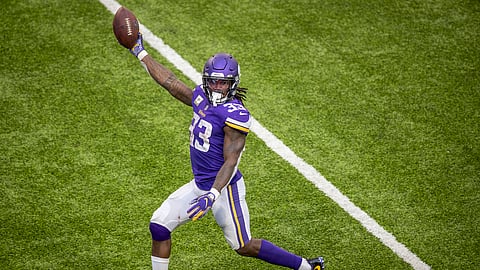 Minnesota Vikings running back Dalvin Cook holds the ball up as he runs into the end zone during the second half of an NFL football game against the Detroit Lions, Sunday, Nov. 8, 2020 in Minneapolis.