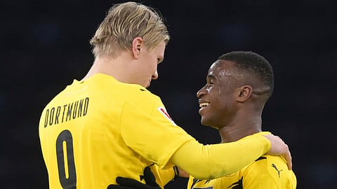 Dortmund's Erling Haaland, left, and Youssoufa Moukoko hug each other after the end of the game a German Bundesliga soccer match between Hertha BSC Berlin and Borussia Dortmund in Berlin, Germany on Saturday, Nov.21, 2020.