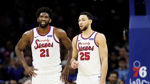 In this Dec. 13, 2019, file photo, Philadelphia 76ers' Ben Simmons, right, and Joel Embiid talk during an NBA basketball game against the New Orleans Pelicans in Philadelphia. The 76ers new coach Doc Rivers is set to begin his first training camp with the team trying to unlock the potential of All-Stars Ben Simmons and Joel Embiid.