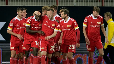 Union's Taiwo Awoniyi, second left, celebrates with teammates after scoring his side's first goal of the game during the German Bundesliga soccer match between 1. FC Union Berlin and Borussia Dortmund at the Stadion Alte Forsterei in Berlin, Friday, Dec. 18, 2020.