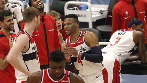 Washington Wizards Russell Westbrook (4) talks with Washington Wizards Davis Bertans (42) during the first half of a preseason NBA basketball game against the Detroit Pistons, Saturday, Dec. 19, 2020, in Washington.