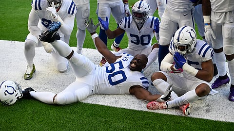 Indianapolis Colts defensive end Justin Houston (50) and teammates celebrate a fumble recovery by Houston Texans quarterback Deshaun Watson during the second half of an NFL football game Sunday, Dec. 6, 2020, in Houston.