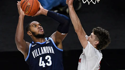 Villanova's Eric Dixon, left, shoots over Hartford's Hunter Marks in the first half of an NCAA college basketball game, Tuesday, Dec. 1, 2020, in Uncasville, Conn.