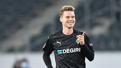 Moenchengladbach's Nico Elvedi celebrates after scoring his side's second goal during the Champions League, Group B, soccer match between Borussia Moenchengladbach and Shakhtar Donetsk at the Borussia Park in Moenchengladbach, Germany, Wednesday, Nov. 25, 2020.