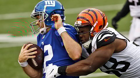 New York Giants quarterback Colt McCoy (12) is tackled by Cincinnati Bengals defensive end Carl Lawson (58) , Sunday, Nov. 29, 2020, in Cincinnati. This could be a familiar picture against the Seahawks.