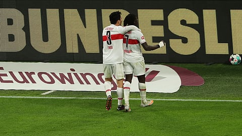 Stuttgart's Wataru Endo, left, and Tanguy Coulibaly celebrate during the German Bundesliga soccer match between Borussia Dortmund and VfB Stuttgart in Dortmund, Germany, Saturday, Dec. 12, 2020.