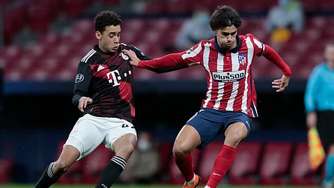 Atletico Madrid's Joao Felix, right, duels for the balls with Bayern's Jamal Musiala during the Champions League group A soccer match between Atletico Madrid and Bayern Munich at the Wanda Metropolitano stadium in Madrid, Spain, Tuesday, Dec. 1, 2020.