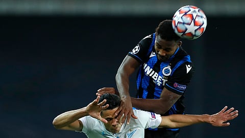 Zenit's Douglas Santos, left, goes up for the ball against Brugge's Emmanuel Bonaventure during a Champions league Group F soccer match between Brugge and Zenit at the Jan Breydel stadium in Bruges, Belgium, Wednesday, Dec. 2, 2020.