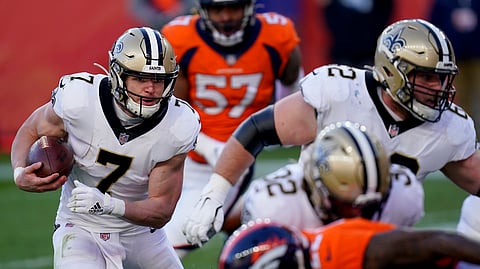 New Orleans Saints quarterback Taysom Hill (7) runs in for a touchdown during the first half of an NFL football game against the Denver Broncos, Sunday, Nov. 29, 2020, in Denver.