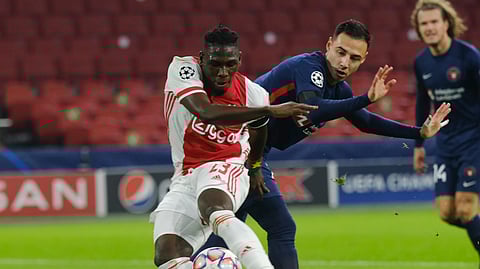 Ajax's Lassina Traore, front, and Midtjylland's Paulinho vie for the ball during the group D Champions League soccer match between Ajax and Midtjylland at the Johan Cruyff ArenA in Amsterdam, Netherlands, Wednesday, Nov. 25, 2020.