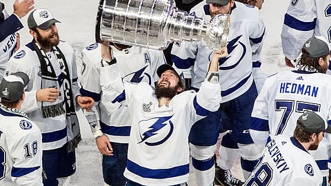 FILE - In this Sept. 28, 2020, file photo, Tampa Bay Lightning's Nikita Kucherov (86) hoists the Stanley Cup after defeating the Dallas Stars in the NHL Stanley Cup hockey finals in Edmonton, Alberta. Kucherov is expected to miss the entire regular season because of a hip injury that requires surgery. General manager Julien BriseBois ruled out Kucherov for the 56-game season that begins Jan. 13 and ends May 8.